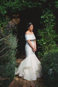 Beautiful off the shoulder style wedding gown made from silk dupion and silk organza by Clasch Design